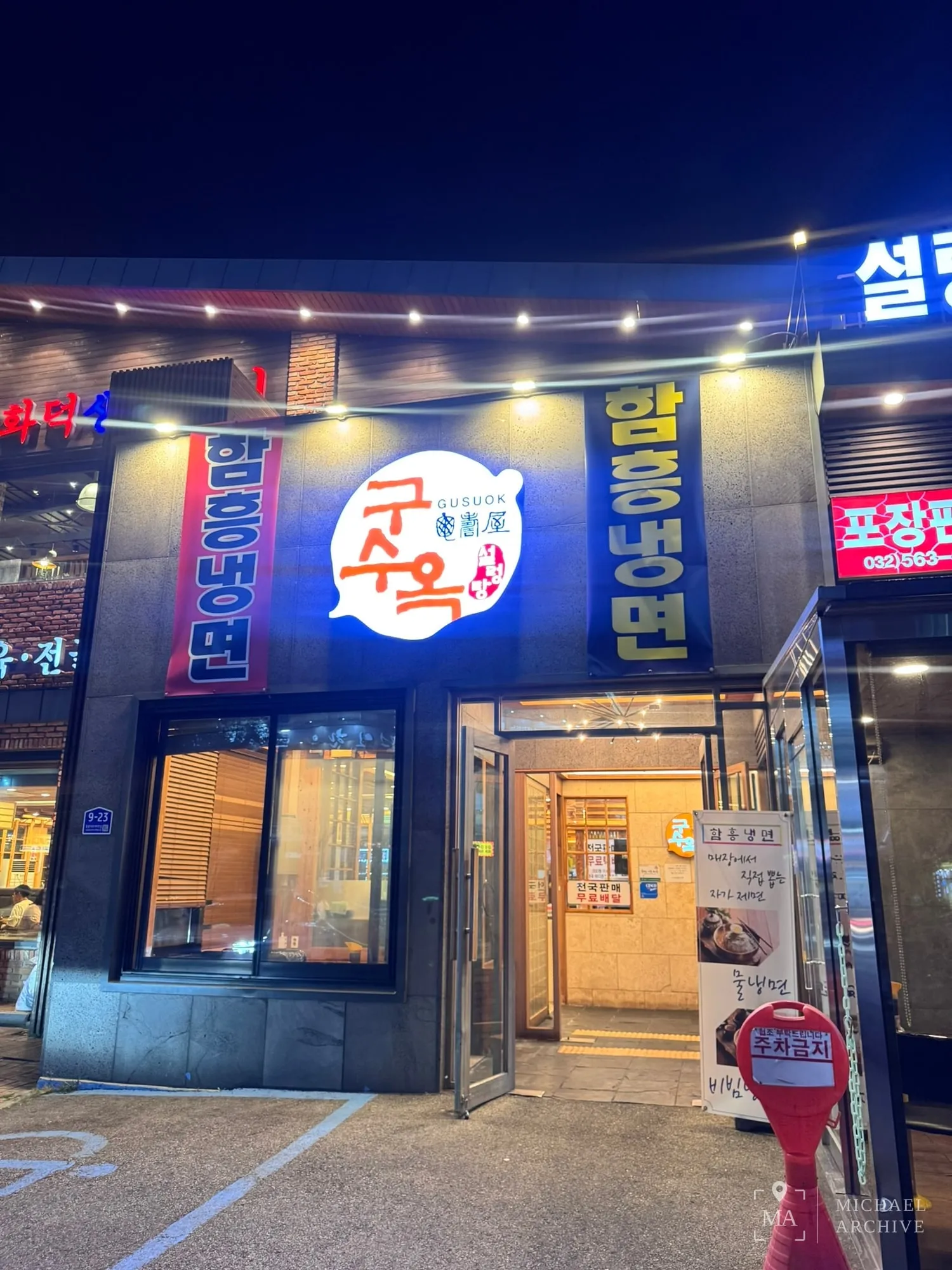 밤의 구수옥 간판 — 가운데 구수옥 로고, 양옆에 함흥냉면 배너