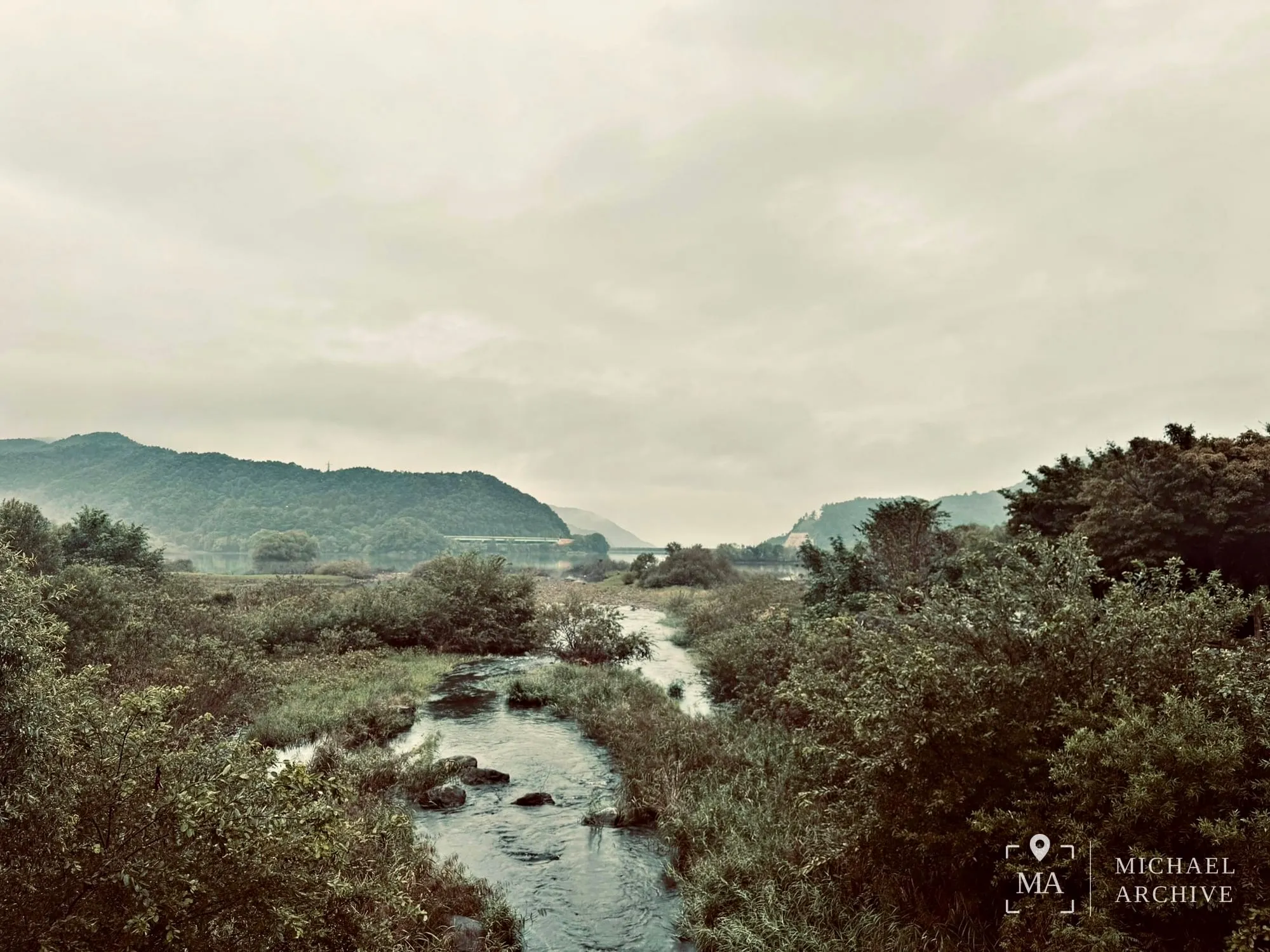 흐린 아침의 천변 — 물길과 그 너머 호수